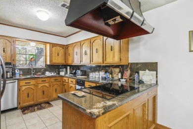 Nestled on Tree-shaded bayou, this waterfront retreat offers on Belle Oaks Golf Club in Texas - for sale on GolfHomes.com, golf home, golf lot