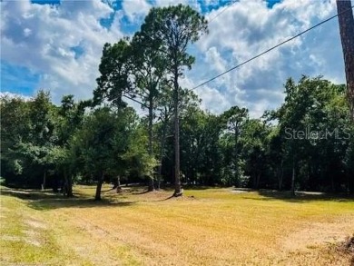 This prime .46-acre canal-front lot is located in the serene on River Greens Golf Course in Florida - for sale on GolfHomes.com, golf home, golf lot