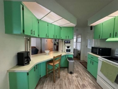Turnkey 2-Bedroom, 2-Bath Home with Breathtaking Lake Views in on Vista Plantation Golf Club in Florida - for sale on GolfHomes.com, golf home, golf lot