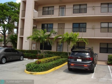 This 1st floor inside corner condo has an assigned parking spot on Sunrise Lakes Phase IV Golf Course in Florida - for sale on GolfHomes.com, golf home, golf lot