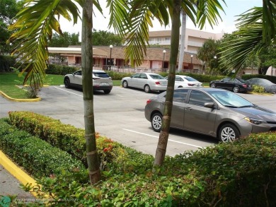 This 1st floor inside corner condo has an assigned parking spot on Sunrise Lakes Phase IV Golf Course in Florida - for sale on GolfHomes.com, golf home, golf lot