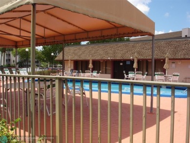 This 1st floor inside corner condo has an assigned parking spot on Sunrise Lakes Phase IV Golf Course in Florida - for sale on GolfHomes.com, golf home, golf lot