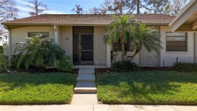 Welcome to this spacious 4-bedroom, 2-bathroom corner-unit villa on East Lake Woodlands Country Club in Florida - for sale on GolfHomes.com, golf home, golf lot