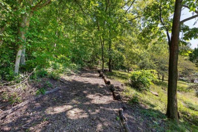 Nestled amidst the scenic beauty of mature trees and lush on Eagle Ridge Inn and Resort in Illinois - for sale on GolfHomes.com, golf home, golf lot