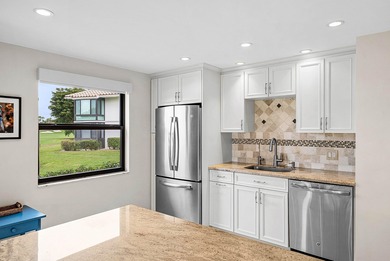 Exceptional golf course views wrap around this renovated on Quail Ridge Golf Course and Country Club in Florida - for sale on GolfHomes.com, golf home, golf lot