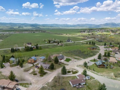 Nestled on a meticulously landscaped lot with a front-row view on Cedar Creek Golf Course in Wyoming - for sale on GolfHomes.com, golf home, golf lot