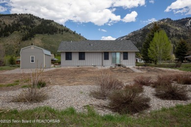 Nestled on a meticulously landscaped lot with a front-row view on Cedar Creek Golf Course in Wyoming - for sale on GolfHomes.com, golf home, golf lot