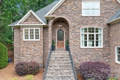 Beautifully updated and impeccably maintained, this custom brick on Cowans Ford Country Club in North Carolina - for sale on GolfHomes.com, golf home, golf lot