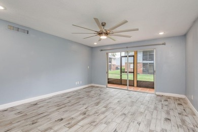 Welcome to this charming first-floor end-unit condo located in on East Bay Golf Club in Florida - for sale on GolfHomes.com, golf home, golf lot