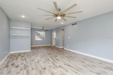 Welcome to this charming first-floor end-unit condo located in on East Bay Golf Club in Florida - for sale on GolfHomes.com, golf home, golf lot