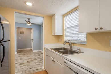 Welcome to this charming first-floor end-unit condo located in on East Bay Golf Club in Florida - for sale on GolfHomes.com, golf home, golf lot