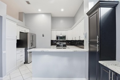 Enjoy relaxed South Florida living in this inviting 3-bedroom on Boca Delray Golf and Country Club in Florida - for sale on GolfHomes.com, golf home, golf lot