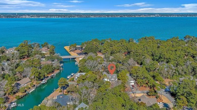 Canalfront 4-bedroom home situated on a private lot in Pine on The Country Club of the Crystal Coast in North Carolina - for sale on GolfHomes.com, golf home, golf lot