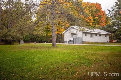 Sitting on a quiet residential street in Hiawatha Township on Indian Lake Golf and Country Club in Michigan - for sale on GolfHomes.com, golf home, golf lot