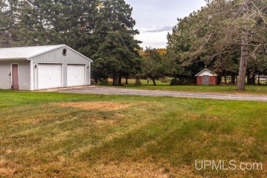 Sitting on a quiet residential street in Hiawatha Township on Indian Lake Golf and Country Club in Michigan - for sale on GolfHomes.com, golf home, golf lot