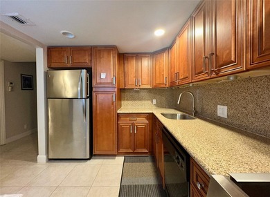 Escape to this spacious 2BR/2BA condo situated in a private on Palm-Aire Country Club and Resort - Palms in Florida - for sale on GolfHomes.com, golf home, golf lot