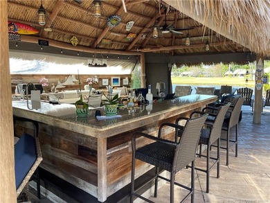 Spectacular sunset views over the lake and golf course set the on St. Lucie Trail Golf Club in Florida - for sale on GolfHomes.com, golf home, golf lot