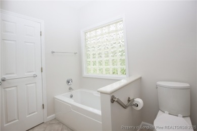 Nestled in the desirable Whispering Pines community and backing on Whispering Woods in North Carolina - for sale on GolfHomes.com, golf home, golf lot