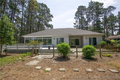 Nestled in the desirable Whispering Pines community and backing on Whispering Woods in North Carolina - for sale on GolfHomes.com, golf home, golf lot