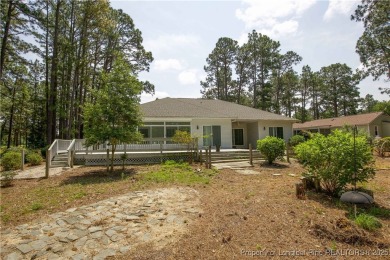 Nestled in the desirable Whispering Pines community and backing on Whispering Woods in North Carolina - for sale on GolfHomes.com, golf home, golf lot