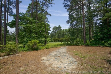 Nestled in the desirable Whispering Pines community and backing on Whispering Woods in North Carolina - for sale on GolfHomes.com, golf home, golf lot