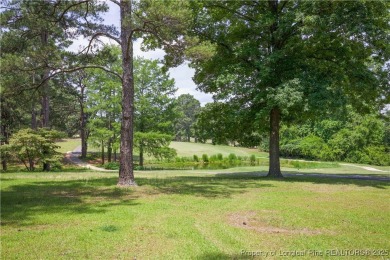 Nestled in the desirable Whispering Pines community and backing on Whispering Woods in North Carolina - for sale on GolfHomes.com, golf home, golf lot