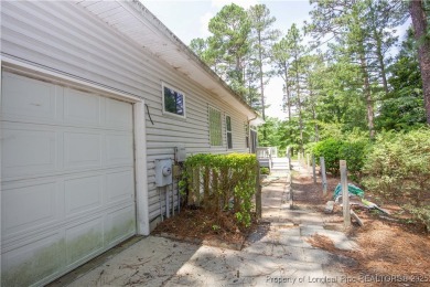 Nestled in the desirable Whispering Pines community and backing on Whispering Woods in North Carolina - for sale on GolfHomes.com, golf home, golf lot