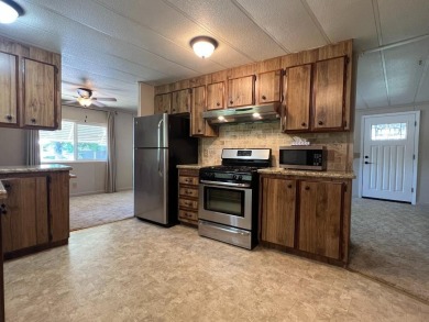 Discover comfort and convenience in this inviting 2-bedroom on Tucker Oaks Golf Course in California - for sale on GolfHomes.com, golf home, golf lot