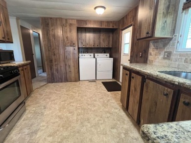 Discover comfort and convenience in this inviting 2-bedroom on Tucker Oaks Golf Course in California - for sale on GolfHomes.com, golf home, golf lot