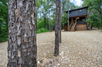 *The Howling Wolf* is a towering getaway cabin at the end of the on Cedar Creek Golf Course At Beavers Bend State Park in Oklahoma - for sale on GolfHomes.com, golf home, golf lot