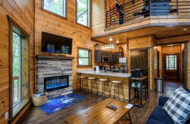 *The Howling Wolf* is a towering getaway cabin at the end of the on Cedar Creek Golf Course At Beavers Bend State Park in Oklahoma - for sale on GolfHomes.com, golf home, golf lot