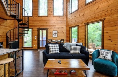 *The Howling Wolf* is a towering getaway cabin at the end of the on Cedar Creek Golf Course At Beavers Bend State Park in Oklahoma - for sale on GolfHomes.com, golf home, golf lot