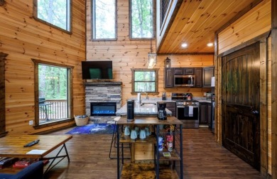 *The Howling Wolf* is a towering getaway cabin at the end of the on Cedar Creek Golf Course At Beavers Bend State Park in Oklahoma - for sale on GolfHomes.com, golf home, golf lot