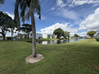 Ground floor 2 bedroom, 2 bath true corner unit with canal view on Addison Reserve in Florida - for sale on GolfHomes.com, golf home, golf lot