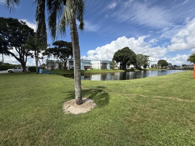 Ground floor 2 bedroom, 2 bath true corner unit with canal view on Addison Reserve in Florida - for sale on GolfHomes.com, golf home, golf lot