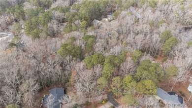 Build your dream home on this beautiful .47-acre wooded lot on Carolina Trace Country Club in North Carolina - for sale on GolfHomes.com, golf home, golf lot