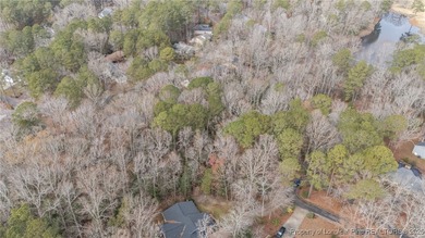 Build your dream home on this beautiful .47-acre wooded lot on Carolina Trace Country Club in North Carolina - for sale on GolfHomes.com, golf home, golf lot