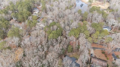 Build your dream home on this beautiful .47-acre wooded lot on Carolina Trace Country Club in North Carolina - for sale on GolfHomes.com, golf home, golf lot