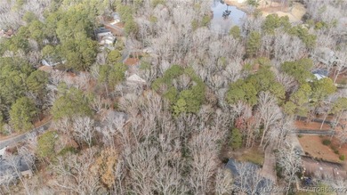 Build your dream home on this beautiful .47-acre wooded lot on Carolina Trace Country Club in North Carolina - for sale on GolfHomes.com, golf home, golf lot