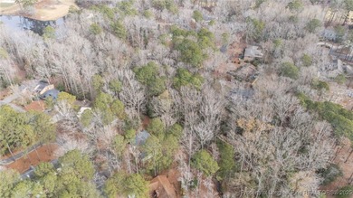 Build your dream home on this beautiful .47-acre wooded lot on Carolina Trace Country Club in North Carolina - for sale on GolfHomes.com, golf home, golf lot