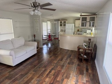 Welcome home to this lovely 2-bedroom, 2-bath oasis in the 55+ on Lake Henry Golf Club in Florida - for sale on GolfHomes.com, golf home, golf lot