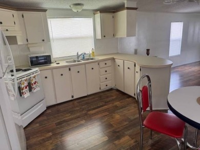 Welcome home to this lovely 2-bedroom, 2-bath oasis in the 55+ on Lake Henry Golf Club in Florida - for sale on GolfHomes.com, golf home, golf lot