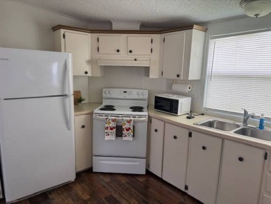 Welcome home to this lovely 2-bedroom, 2-bath oasis in the 55+ on Lake Henry Golf Club in Florida - for sale on GolfHomes.com, golf home, golf lot