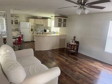 Welcome home to this lovely 2-bedroom, 2-bath oasis in the 55+ on Lake Henry Golf Club in Florida - for sale on GolfHomes.com, golf home, golf lot