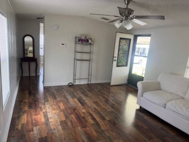 Welcome home to this lovely 2-bedroom, 2-bath oasis in the 55+ on Lake Henry Golf Club in Florida - for sale on GolfHomes.com, golf home, golf lot