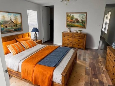 Welcome home to this lovely 2-bedroom, 2-bath oasis in the 55+ on Lake Henry Golf Club in Florida - for sale on GolfHomes.com, golf home, golf lot
