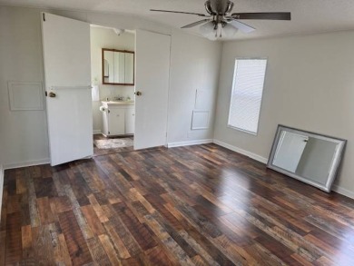 Welcome home to this lovely 2-bedroom, 2-bath oasis in the 55+ on Lake Henry Golf Club in Florida - for sale on GolfHomes.com, golf home, golf lot