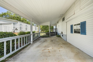 This home is nestled on a picturesque homesite on a quaint on Topsail Green Golf Club in North Carolina - for sale on GolfHomes.com, golf home, golf lot