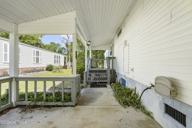 This home is nestled on a picturesque homesite on a quaint on Topsail Green Golf Club in North Carolina - for sale on GolfHomes.com, golf home, golf lot