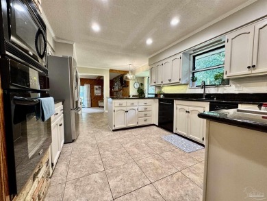 Welcome to 9754 Quail Hollow, situated on the 15th fairway of on Scenic Hills Country Club in Florida - for sale on GolfHomes.com, golf home, golf lot